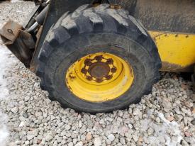 New Holland LS185B Left/Driver Tire and Rim - Used