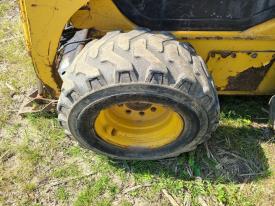 Komatsu SK1026-5N Left/Driver Tire and Rim - Used | P/N 37C30A1200