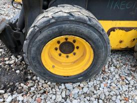 New Holland L220 Left/Driver Tire and Rim - Used