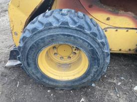 CAT 252B3 Left/Driver Tire and Rim - Used