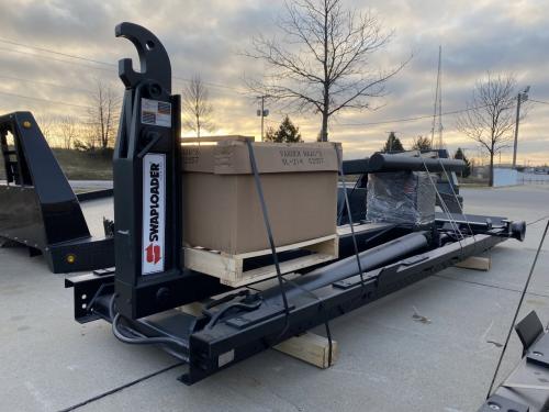 Hooklift, Swaploader SL-214: 20,000# Capacity, 14'-16' Bodies, Adjustable Jib (Hook) 35 5/8"-53 7/8" With  Electric Over Hydraulics Controls, Bi-Rotational Pump (Auto Or Man Trans), Bumper And Led Light Bar